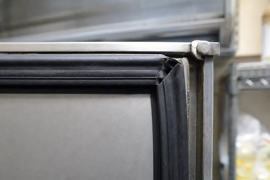 High-detail documentary for “Boulder Restaurant Reach-In: From Failed Temperature Check to Sealed.” Show the key commercial refrigeration gasket, door-seal, measuring, diagnostic or hardware detail involved in “Boulder Restaurant Reach-In: From Failed Temperature Check to Sealed”. Focus on the gasket profile, mitre, magnetic strip, retaining channel, hinge, latch, measurement point or visible failure pattern that supports the article’s explanation. Relevant equipment: Reach-in cooler or freezer, per the real job. Relevant manufacturers when naturally visible: Per the real job. Realistic commercial-kitchen surfaces, accurate proportions, no added labels or text, horizontal composition.