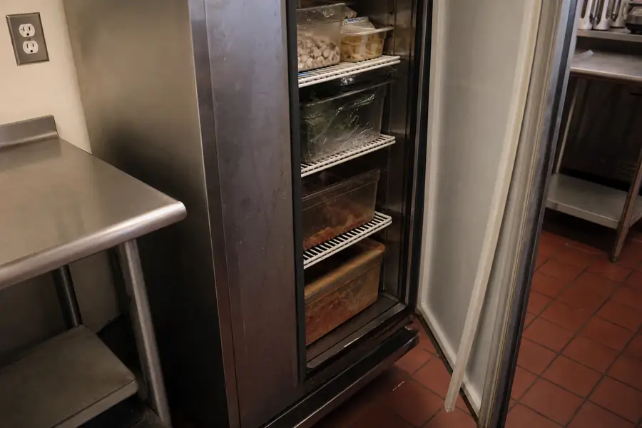 Editorial hero photograph for a commercial foodservice refrigeration article titled “Commercial Refrigerator Door Not Sealing: Work Out Why in Five Minutes.” Show One photo per failure mode. Relevant equipment: Reach-in coolers and freezers; prep tables; undercounter units. Relevant manufacturers when naturally visible: Contextual. Use an authentic restaurant, grocery, school-kitchen or foodservice setting, natural practical lighting, realistic wear and materials, documentary composition, no staged corporate poses, no added text, 16:9 landscape. When the brief requires technical proof, publication should use a real job-site photo instead of an invented representation.