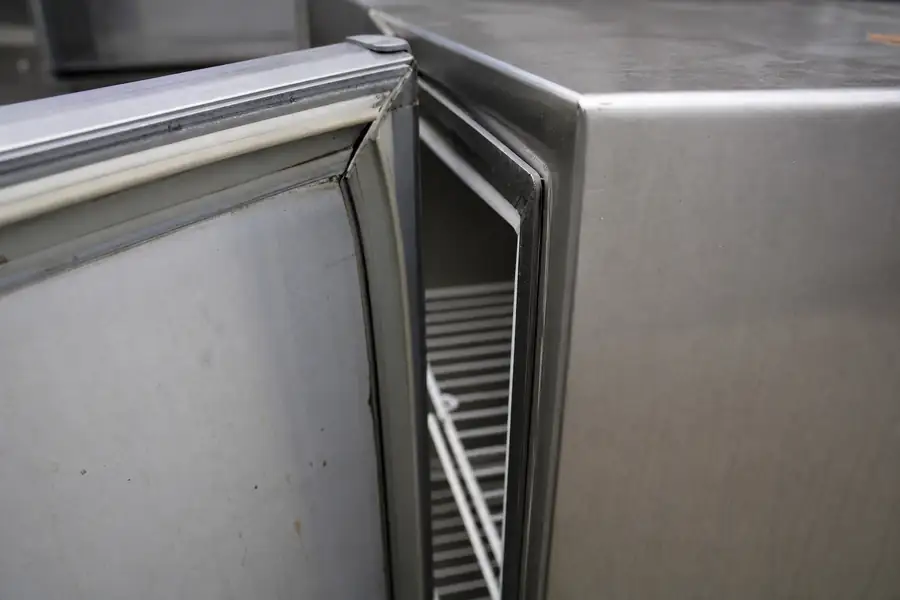 High-detail documentary for “What Commercial Refrigerator Gasket Replacement Costs in Boulder County.” Show profile comparison photo. Focus on the gasket profile, mitre, magnetic strip, retaining channel, hinge, latch, measurement point or visible failure pattern that supports the article’s explanation. Relevant equipment: Reach-in coolers and freezers; walk-ins; prep tables; glass display cases. Relevant manufacturers when naturally visible: Contextual only, no brand price list. Realistic commercial-kitchen surfaces, accurate proportions, no added labels or text, horizontal composition.